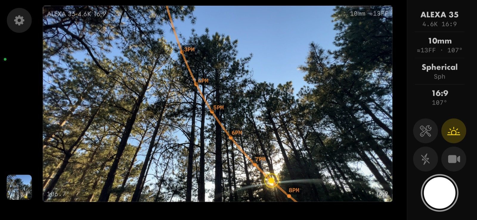 Viewfinder in landscape: sun path overlay across a pine stand, rail controls on the right
