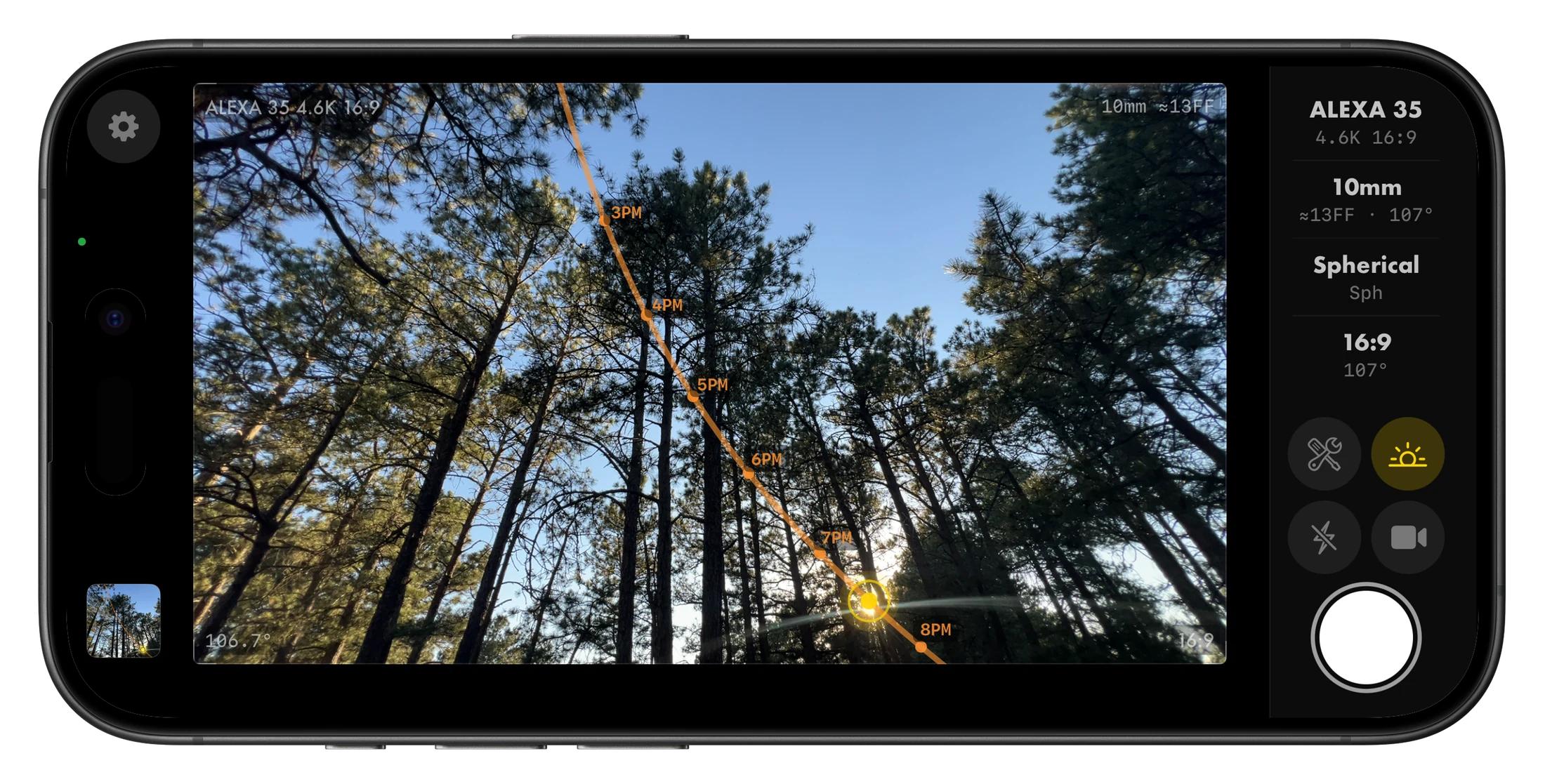 Skopos viewfinder on an iPhone 15 Pro: a low-angle shot up a stand of pines with the sun's arc projected across the sky from 3PM to 8PM, framed for an ARRI ALEXA 35 at 16:9, 10mm.